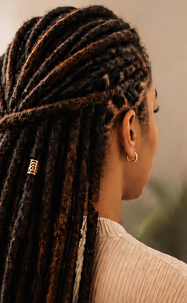 Client with long crochet-method locs, gathered half-up with a gold loc cuff
